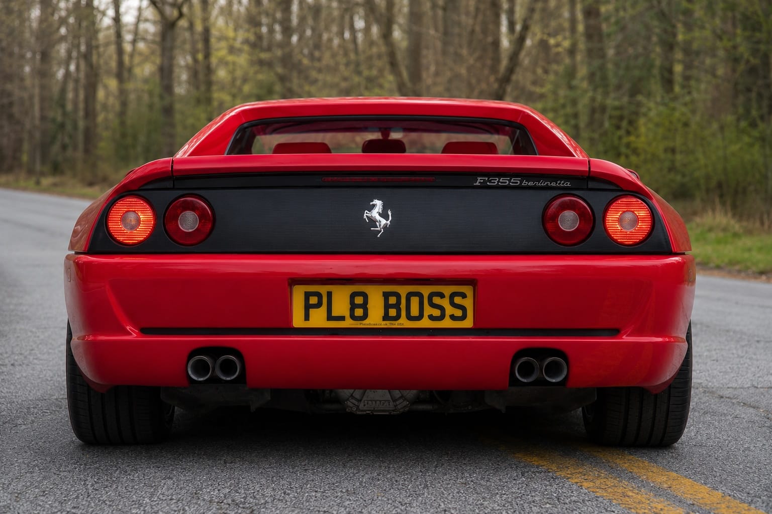 ferrari with a bright yellow UK rear number plate displaying "PL8 BOSS" in raised glossy black 3D gel lettering