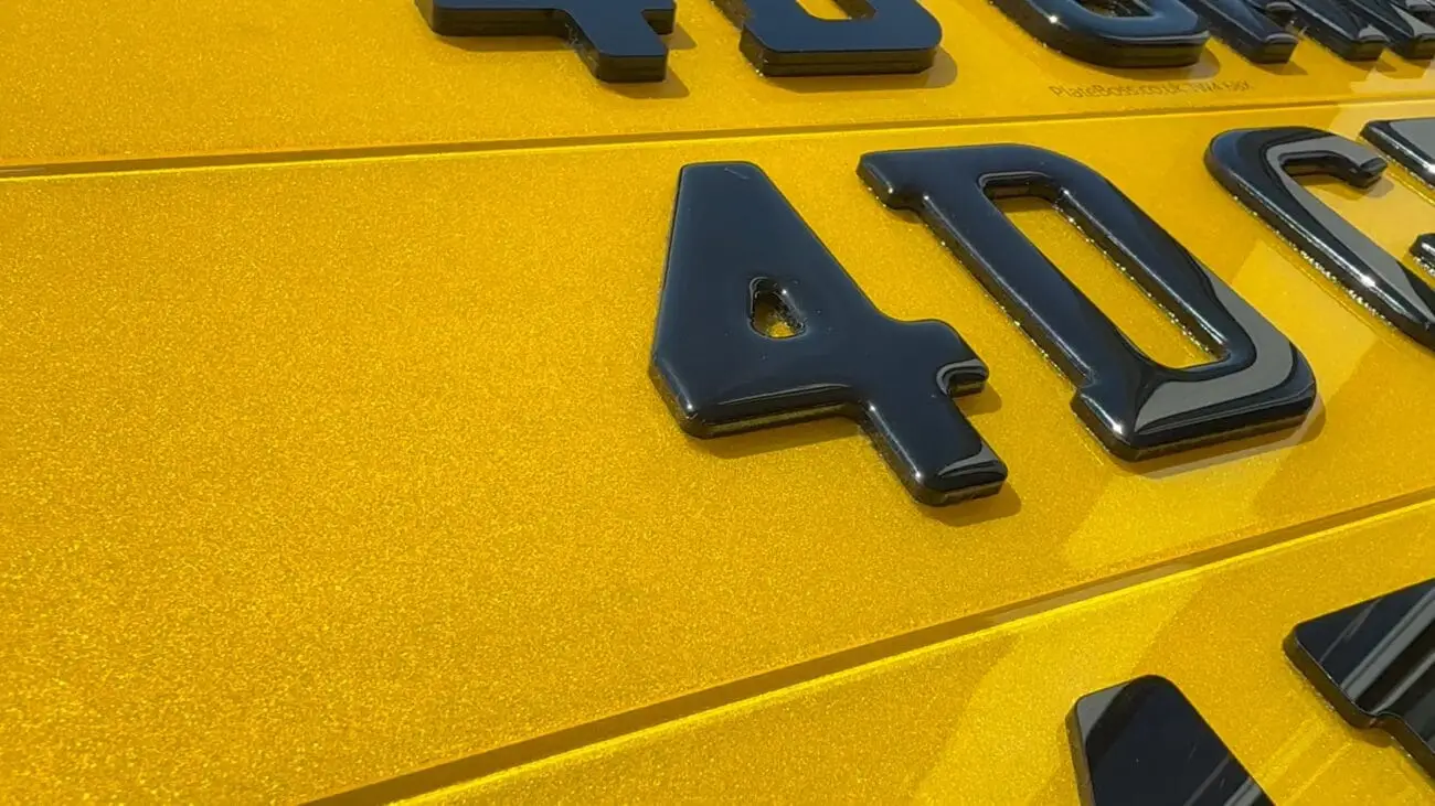 What are 4D number plates? Laser-cut 4D characters standing off a yellow rear plate