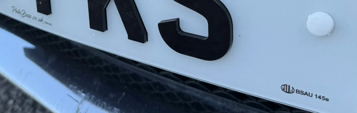 Close-up of the BS AU 145e marking and PlateBoss supplier details on a road-legal number plate