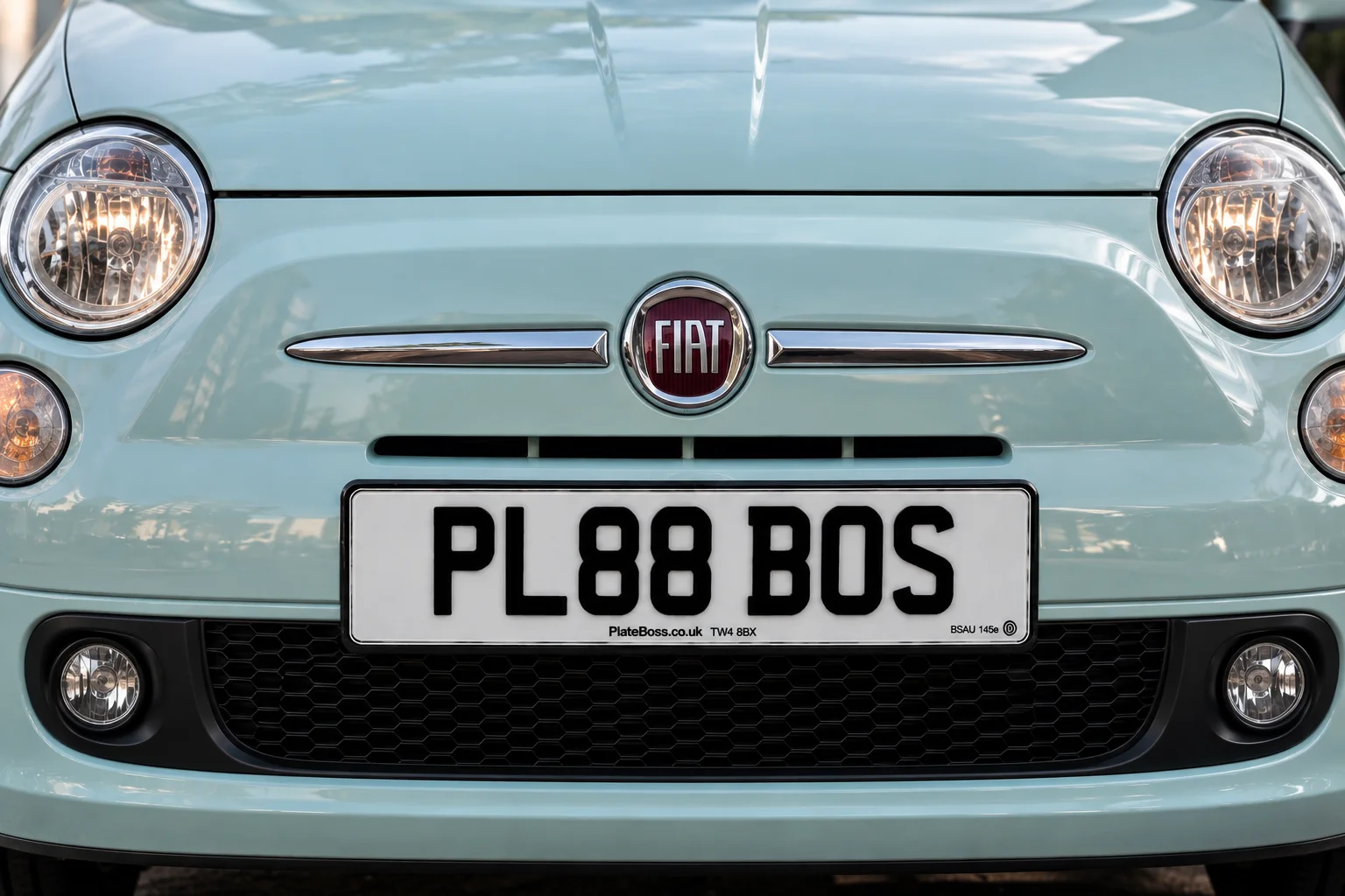 Road-legal white front number plate on a mint green Fiat 500, demo registration PL88 BOS