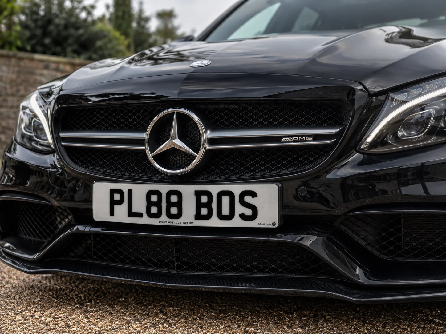 Road-legal front number plate fitted centrally on a black Mercedes-AMG grille, demo registration PL88 BOS