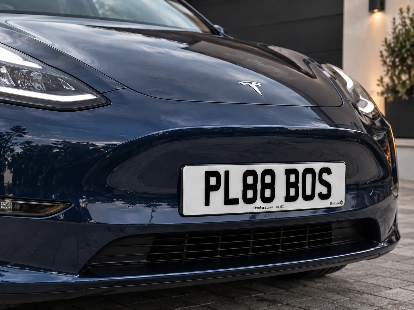 Road-legal front number plate fitted to the bumper of a Tesla, demo registration PL88 BOS