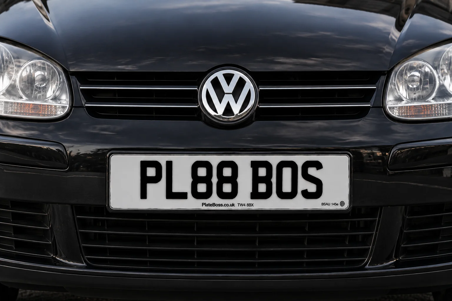 Road-legal white front number plate on a black VW Golf, demo registration PL88 BOS