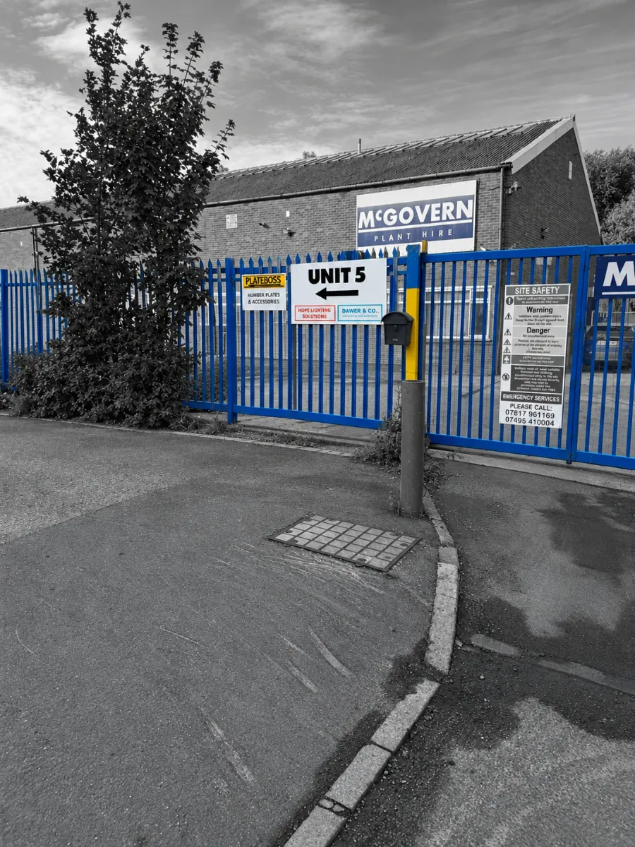 Unit 5 sign with the yellow PlateBoss arrow on the fence by the McGovern gates