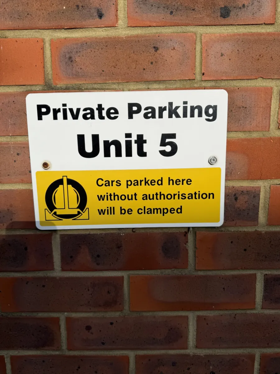Private Parking Unit 5 sign marking the free customer parking bays